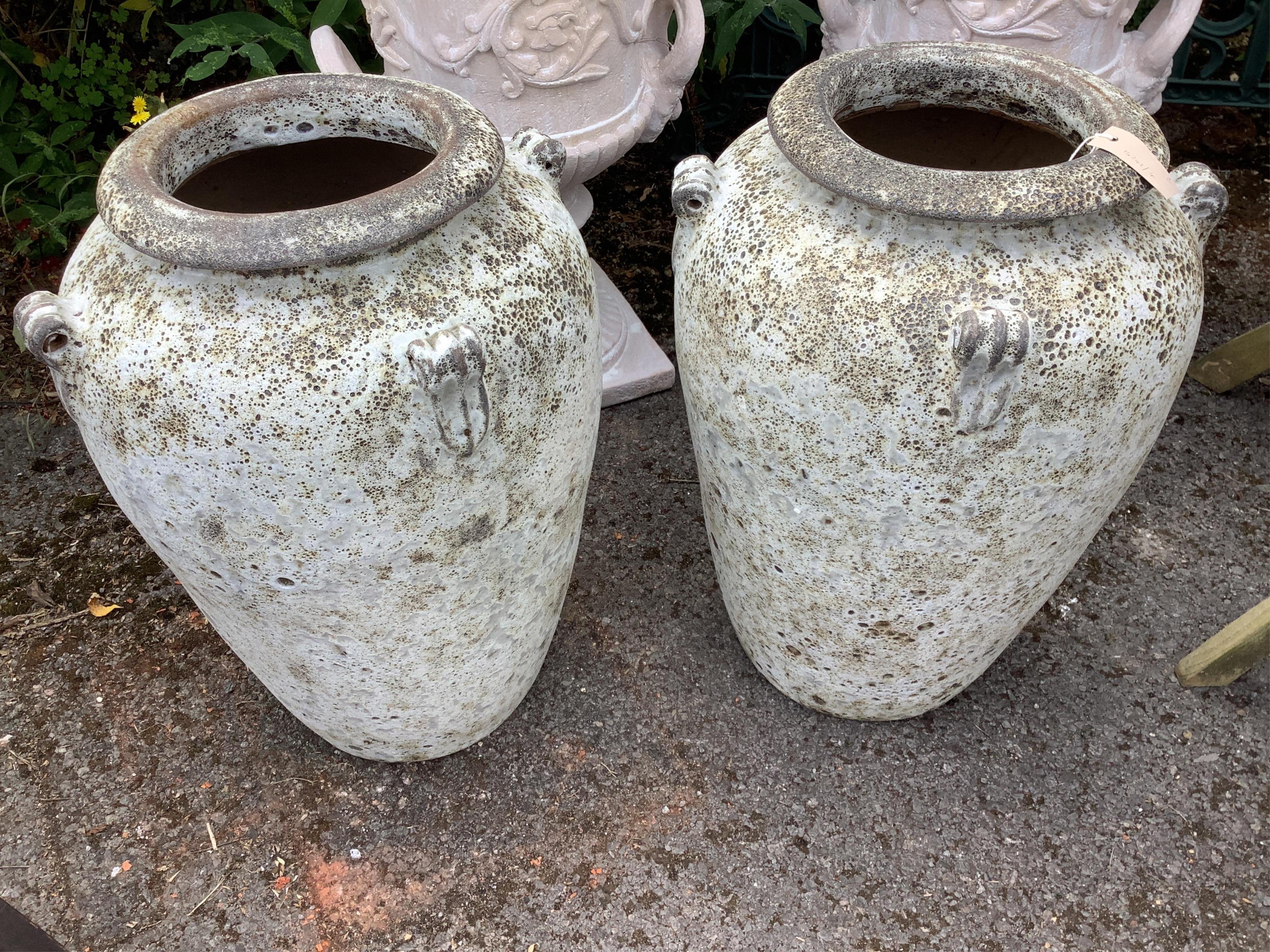 A pair of fire clay amphora urns, height 62cm. Condition - good